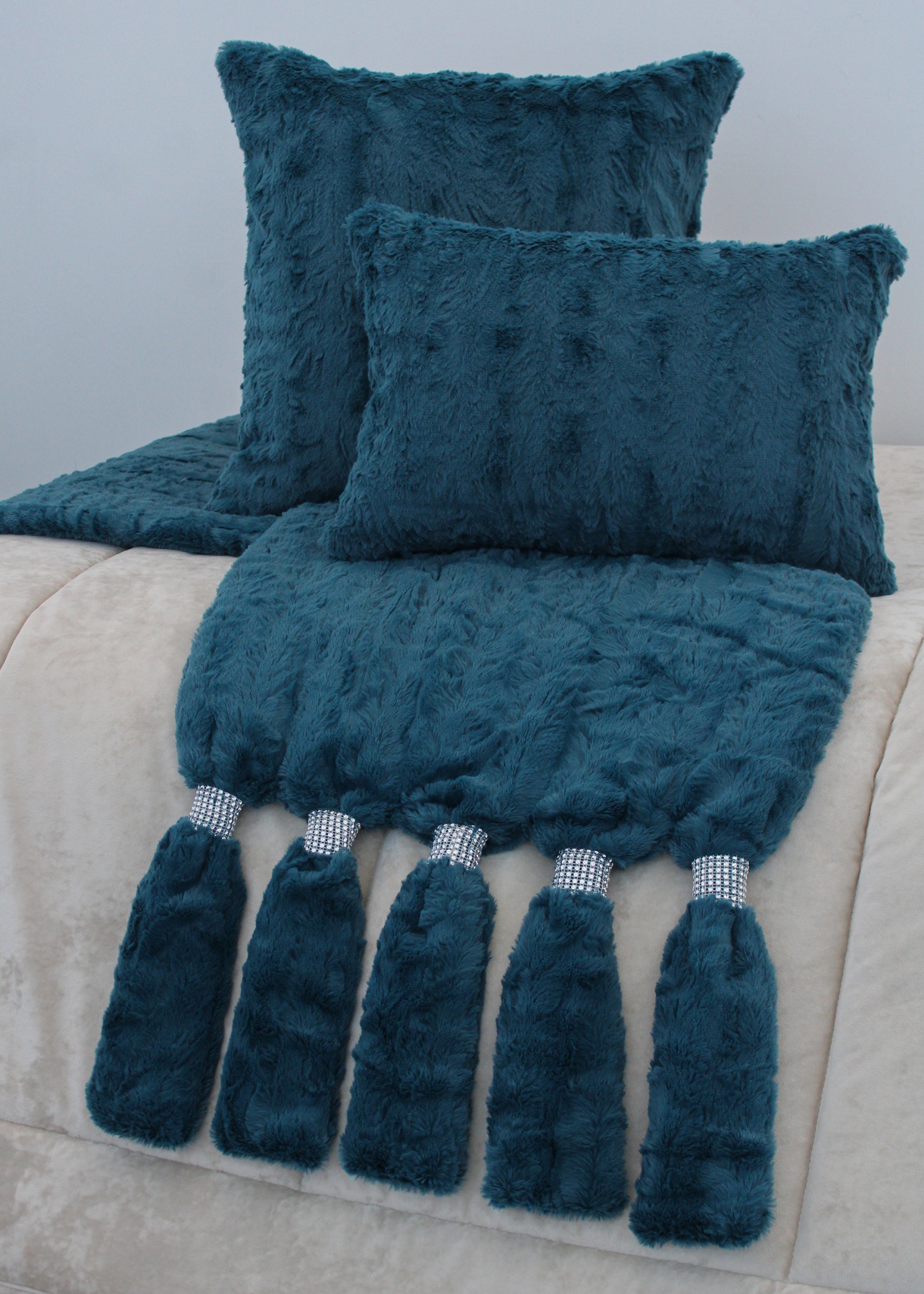 Conjunto de duas almofadas e manta azul escuro felpuda com franjas brilhantes