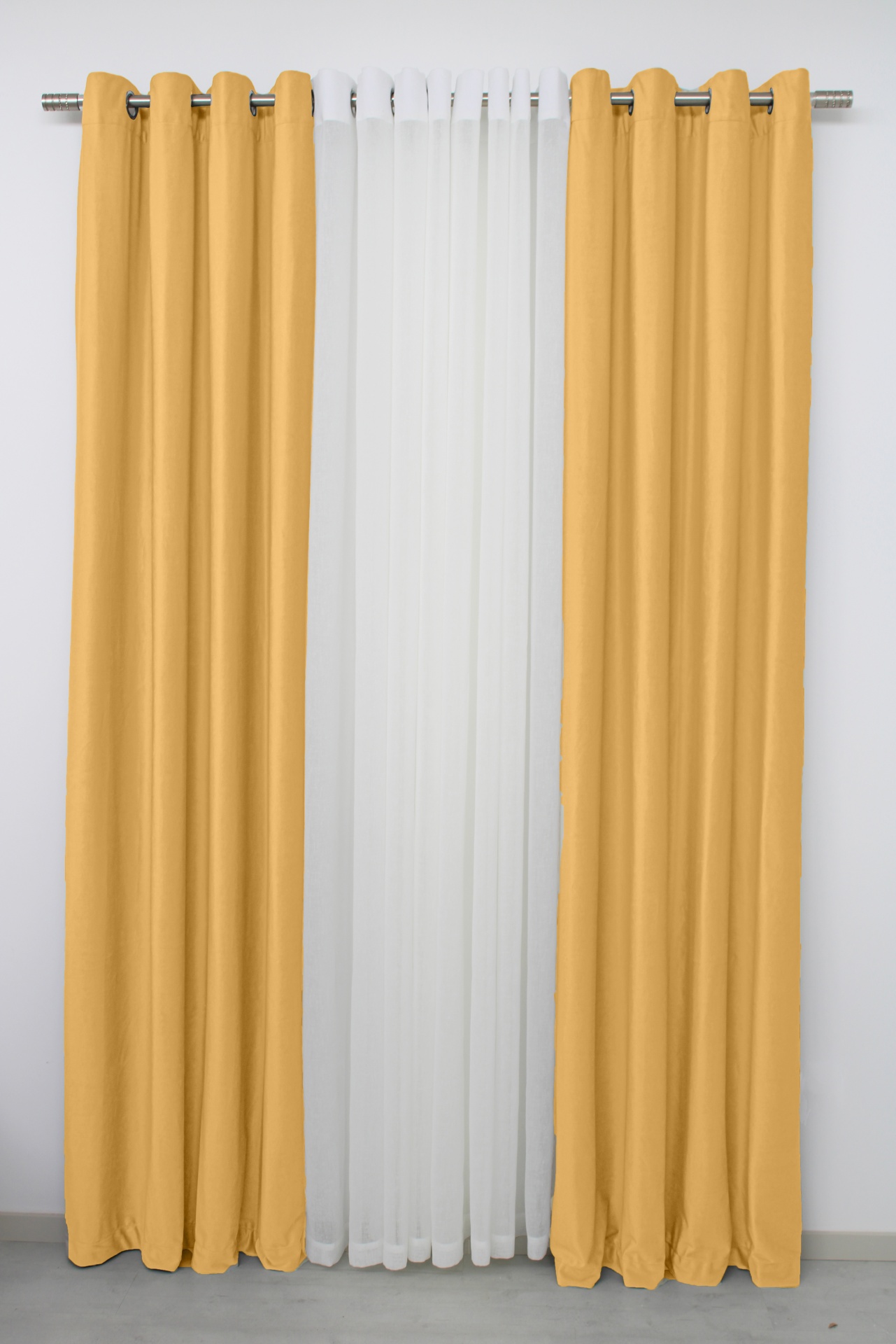 Cortinas amarelas opacas com cortina branca translúcida no meio, penduradas num varão metálico