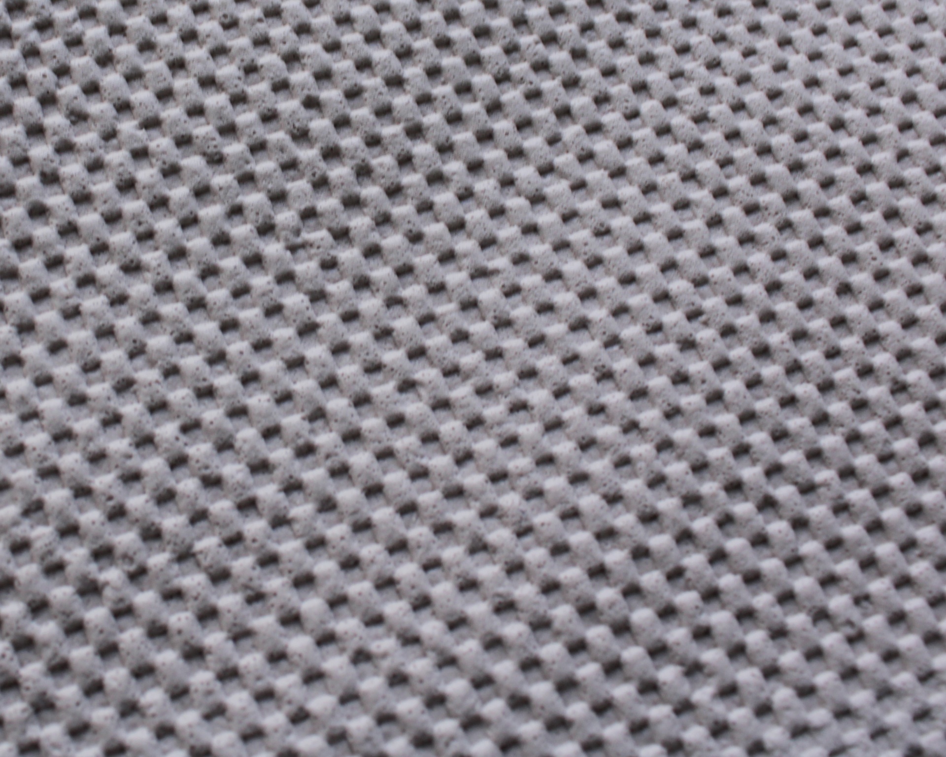 Tecido cinzento texturizado com padrão em relevo de pontos