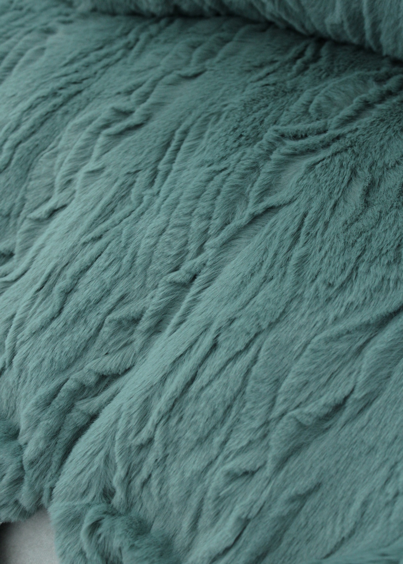 Tecido felpudo verde azulado com textura irregular