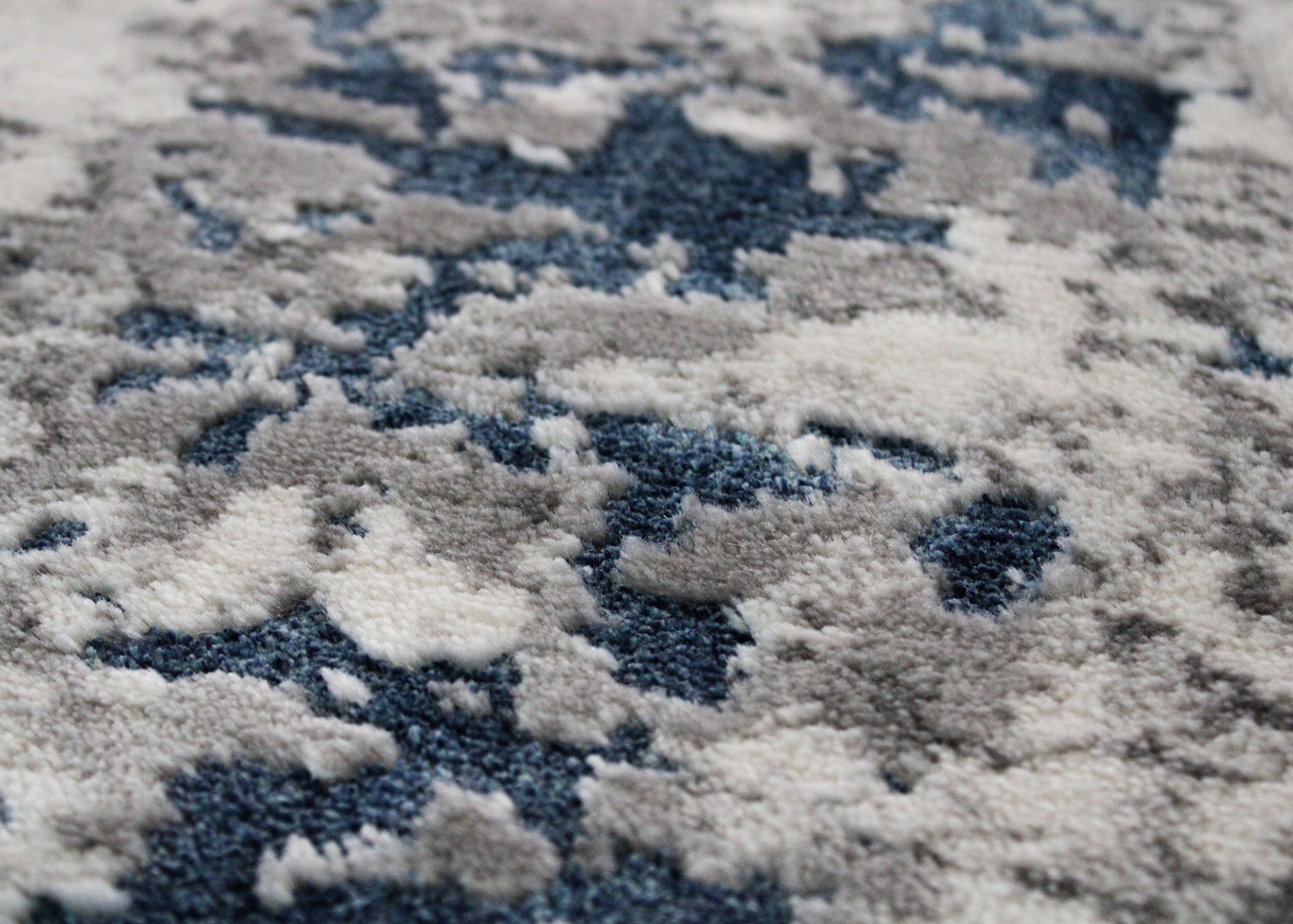 Textura de tapete com padrão abstrato em cinzento e azul