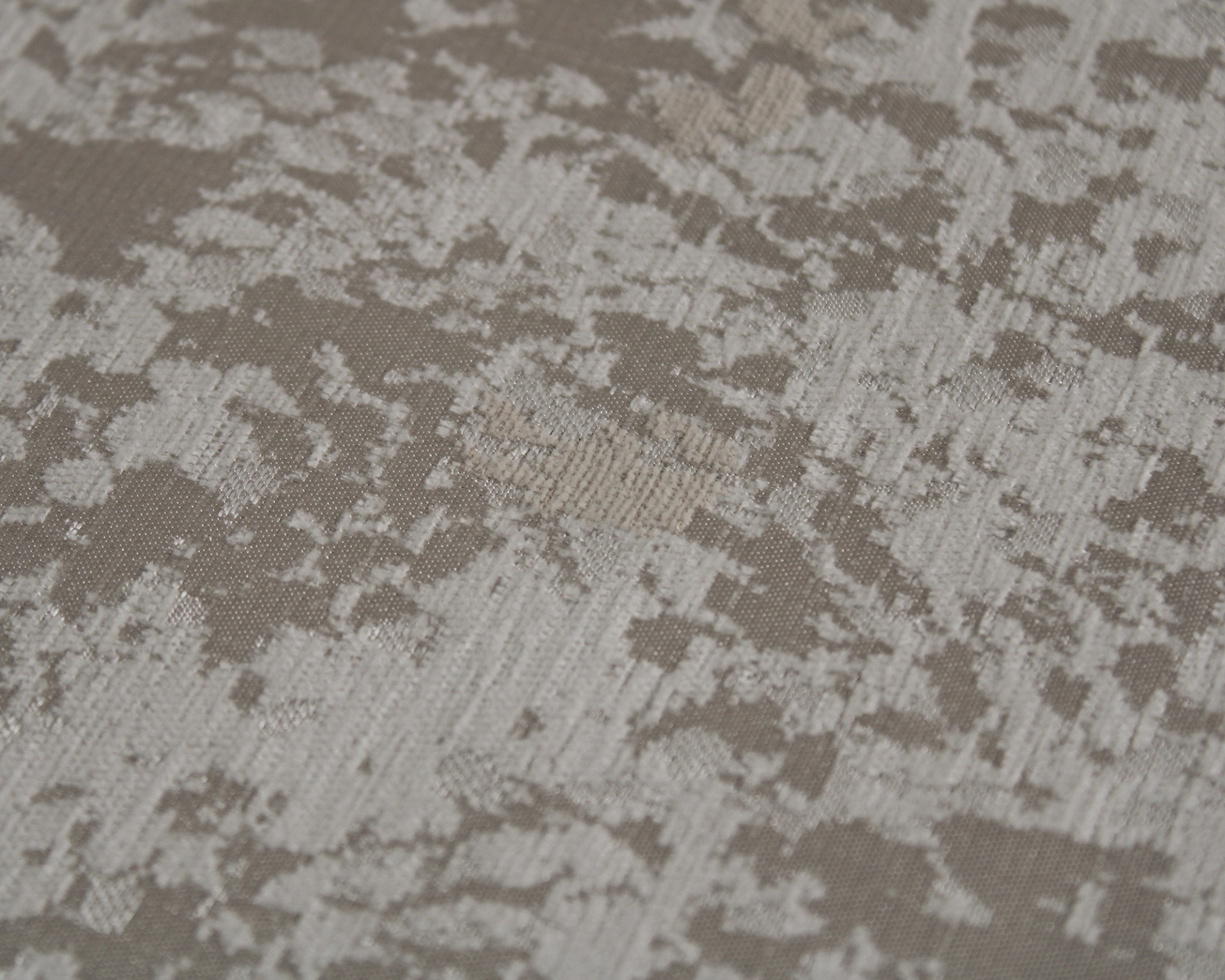 Tecido cinzento e bege com padrão abstracto e textura visível