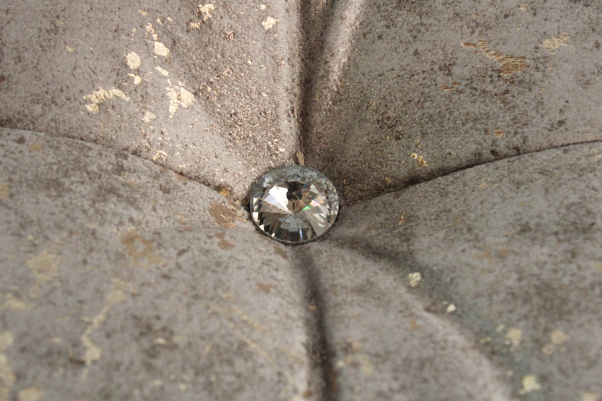 Botão decorativo com pedra brilhante em tecido cinzento aveludado com manchas douradas