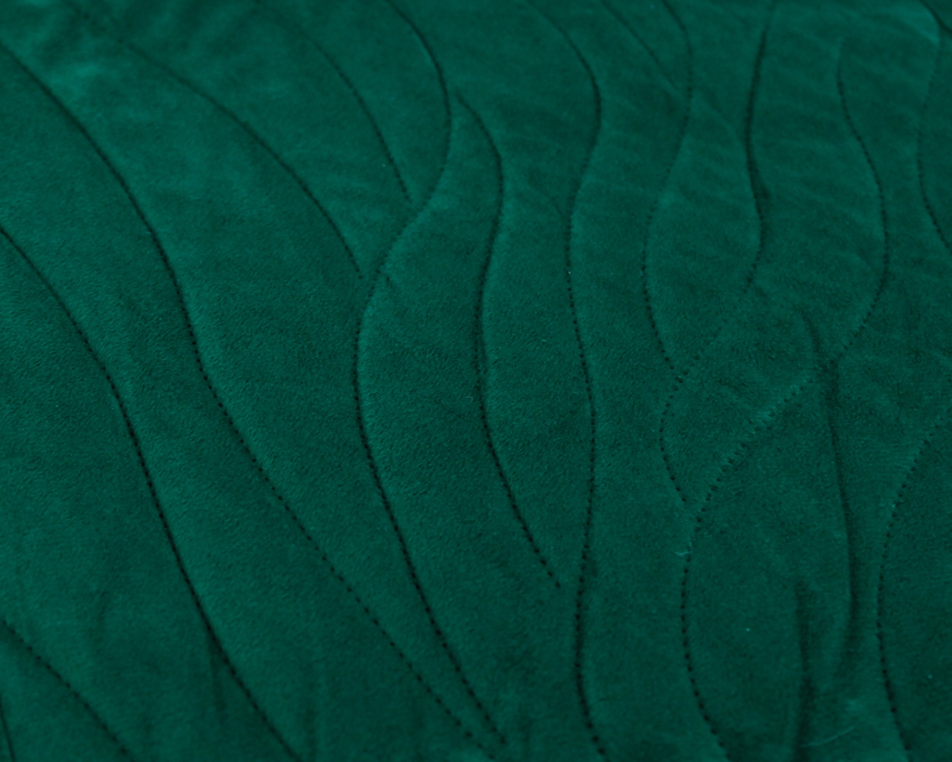 Tecido verde escuro com padrão costurado ondulado
