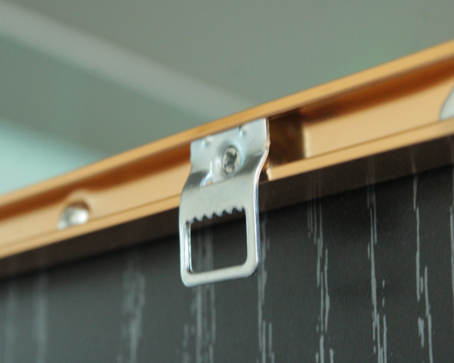 Suporte metálico prateado montado em moldura de madeira clara para pendurar na parede