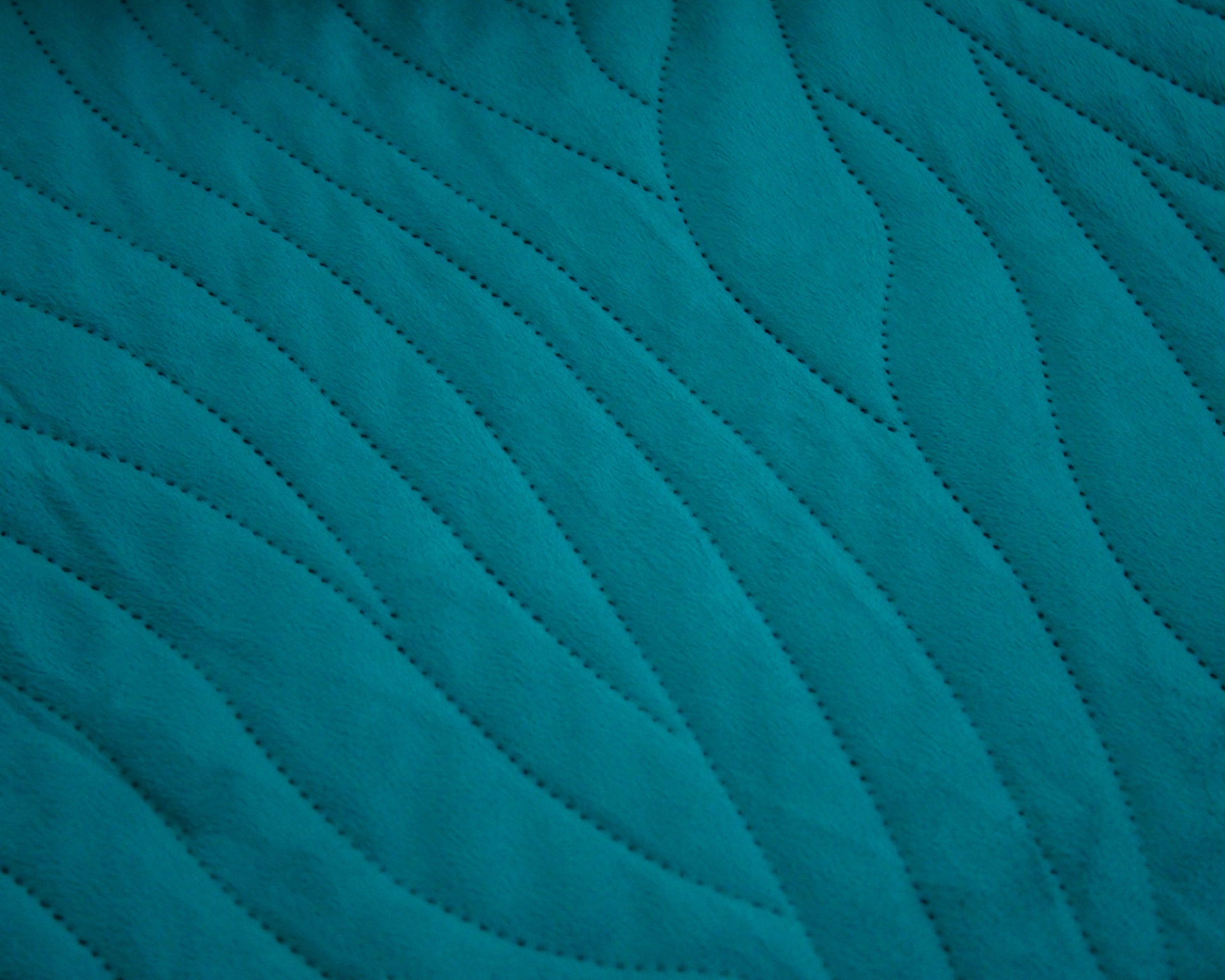 Tecido acolchoado azul-turquesa com padrão ondulado