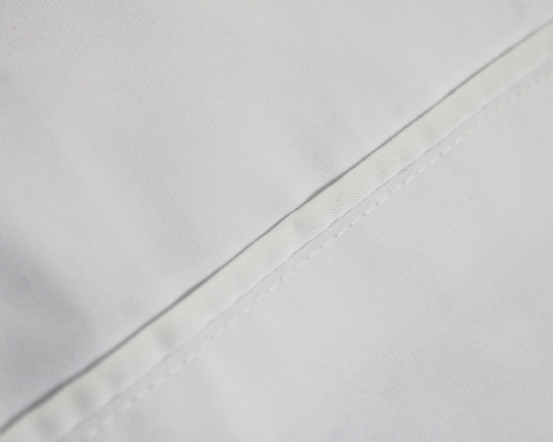 Tecido branco com costura em linha diagonal