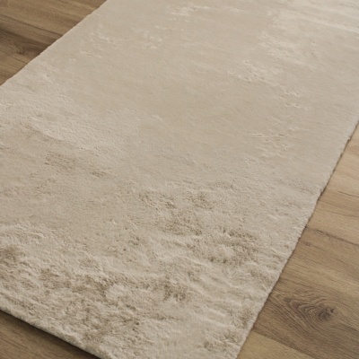 Tapete macio bege claro sobre chão de madeira clara