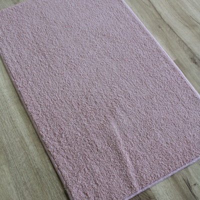 Tapete rosa claro felpudo em chão de madeira clara