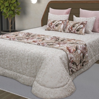 Conjunto de cama com edredão bege, faixa floral e almofadas decorativas em quarto moderno