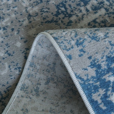 Tapete azul e cinza com padrão abstrato e bordas costuradas