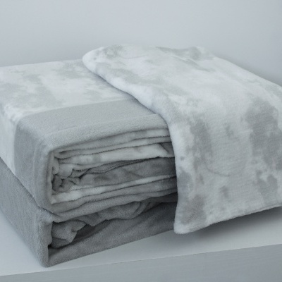 Cobertor macio cinza e branco dobrado