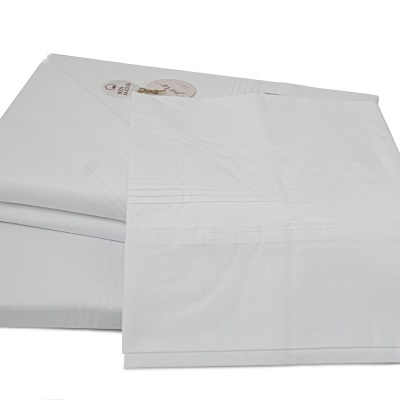 Conjunto de lençóis brancos dobrados com padrão de linhas e etiqueta