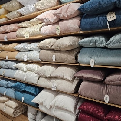 Almofadas de várias cores em prateleiras de madeira