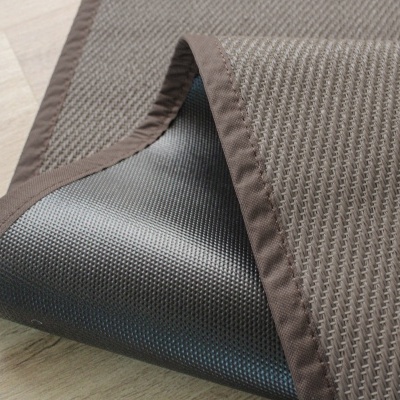tapete castanho texturizado com base antiderrapante preto em chão de madeira clara