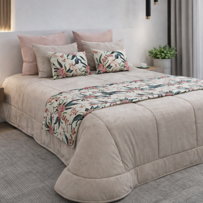 Cama com colcha e almofadas bege e rosa com detalhes florais num quarto moderno