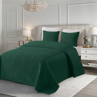 Cama com edredão e fronhas verdes escuras e padrão ondulado em quarto moderno