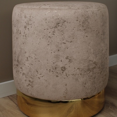 Pufe redondo bege com base dourada em chão de madeira