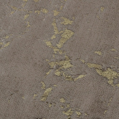 Textura de tecido cinza com manchas douradas irregulares