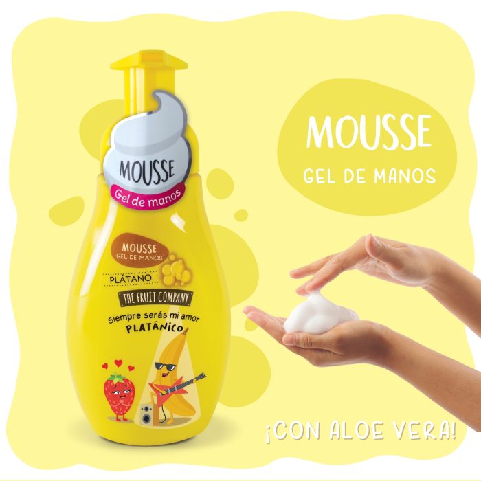 Frasco amarelo de mousse gel de mãos com arte de frutas, mãos com espuma ao lado e fundo amarelo.