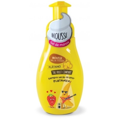 Frasco amarelo de mousse gel para mãos com ilustrações de frutas e texto em castelhano