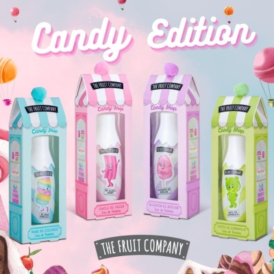 Quatro embalagens coloridas de produtos THE FRUIT COMPANY em formato de casinha com pompom no topo