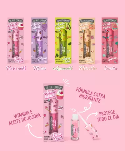 Embalagens coloridas de óleo labial The Fruit Company com texto sobre benefícios, fundo rosa.