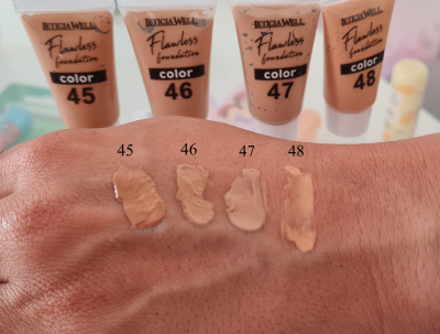 Tubo de base líquida LETICIA WELL Flawless foundation em cores variadas com amostras aplicadas num braço.