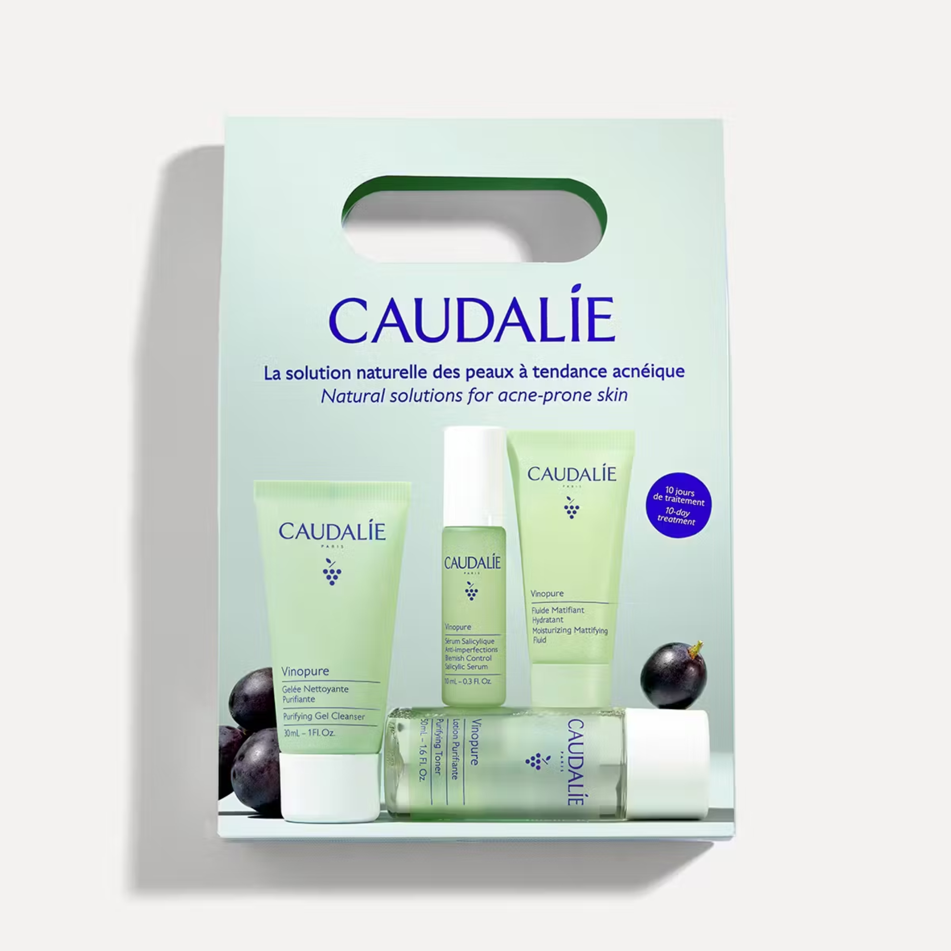 Caudalie - Vinopure Kit Descoberta Caixa branca com conjunto de produtos Caudalie para pele acneica com embalagens verdes