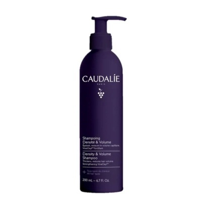 Frasco de champô CAUDALIE roxo escuro com texto branco e dispensador