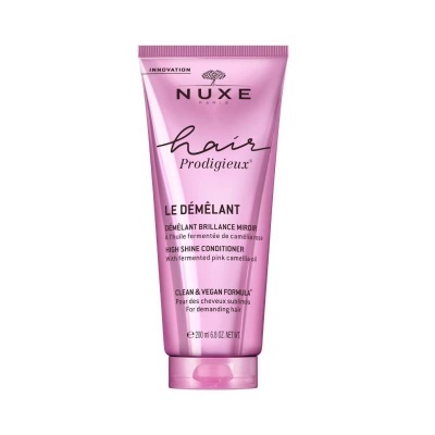 Frasco rosa de condicionador capilar NUXE Hair Prodigieux