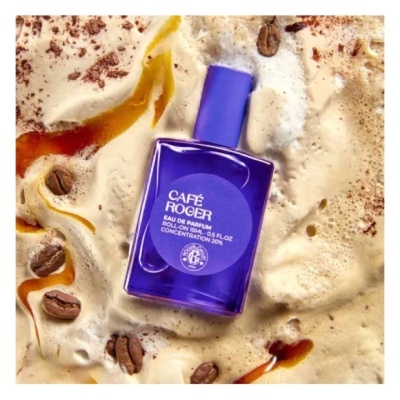 Frasco azul de perfume Café Roger sobre espuma e grãos de café