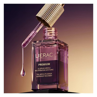 Frasco de sérum rosa com conta-gotas dourado aberto
