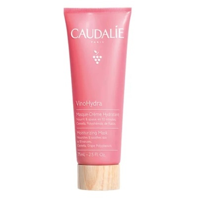 Tubo rosa de creme hidratante Caudalie com tampa de madeira e texto visível