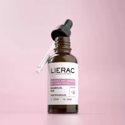 Frasco de sérum LIERAC Bisabolol Pur com conta-gotas sobre fundo cor-de-rosa