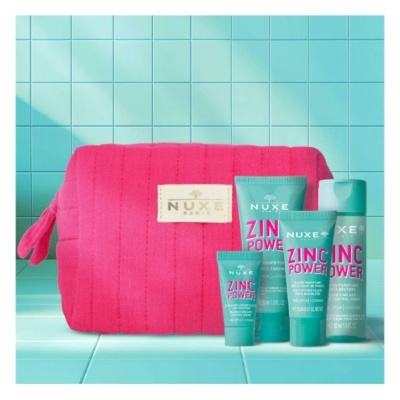 Conjunto de produtos NUXE Zinc Power e necessaire rosa sobre azulejos turquesa