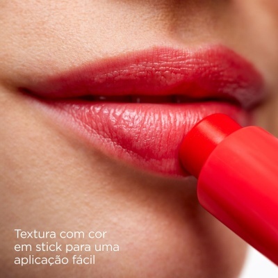 Batom vermelho em stick sendo aplicado nos lábios