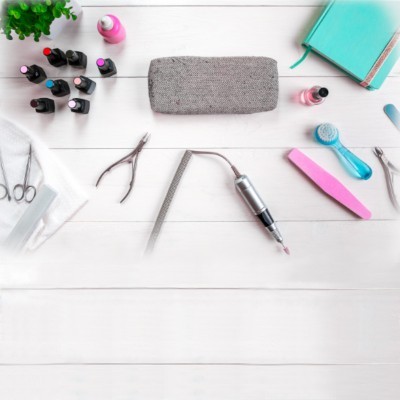 Kit de manicure com utensílios variados sobre mesa branca