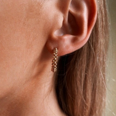 Brinco dourado argola pequena com textura de correntes trançadas na orelha