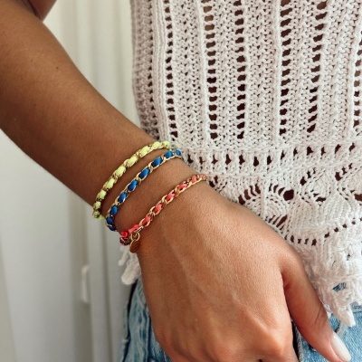 Pulsos com pulseiras coloridas e blusa de crochê branca