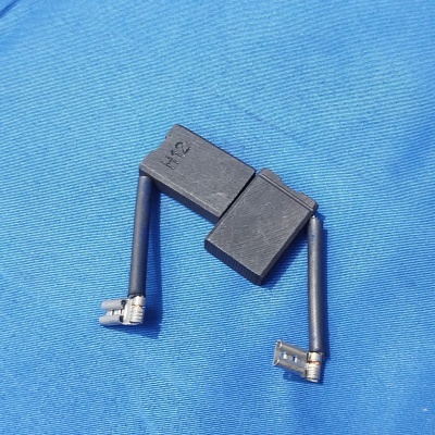 Peças de carvão para motor sobre tecido azul