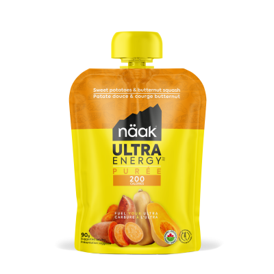 Saco de puré Näak Ultra Energy amarelo e laranja com tampa amarela e imagem de batata-doce e abóbora.