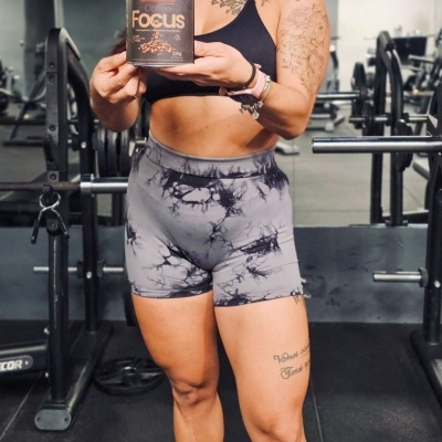 Mulher em academia a segurar frasco Focus NUTRIWHEY