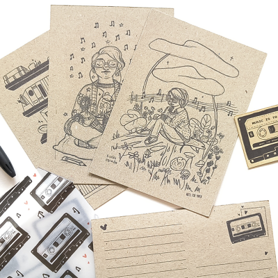 Postais em papel kraft com desenhos a preto de temas musicais e autocolantes de cassetes