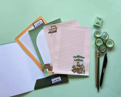 Papel timbrado decorativo com envelope, lápis, caneta e fitas adesivas verdes