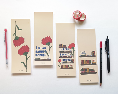 Marcadores de papel com desenhos de livros e cravos e texto I READ BANNED BOOKS