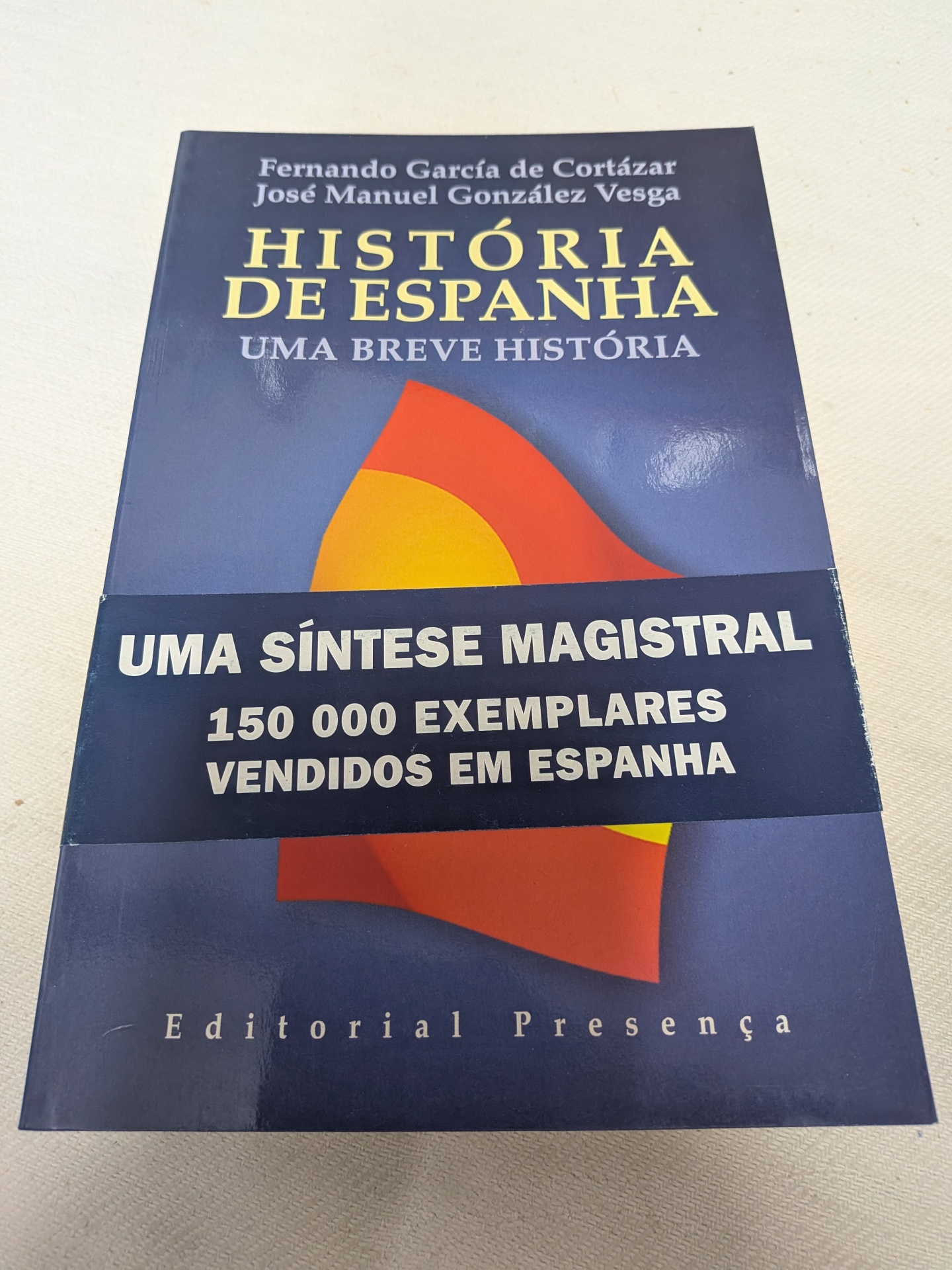 Fernando García de Cortázar - História de Espanha Capa do livro História de Espanha com texto promocional e design simples azul e amarelo