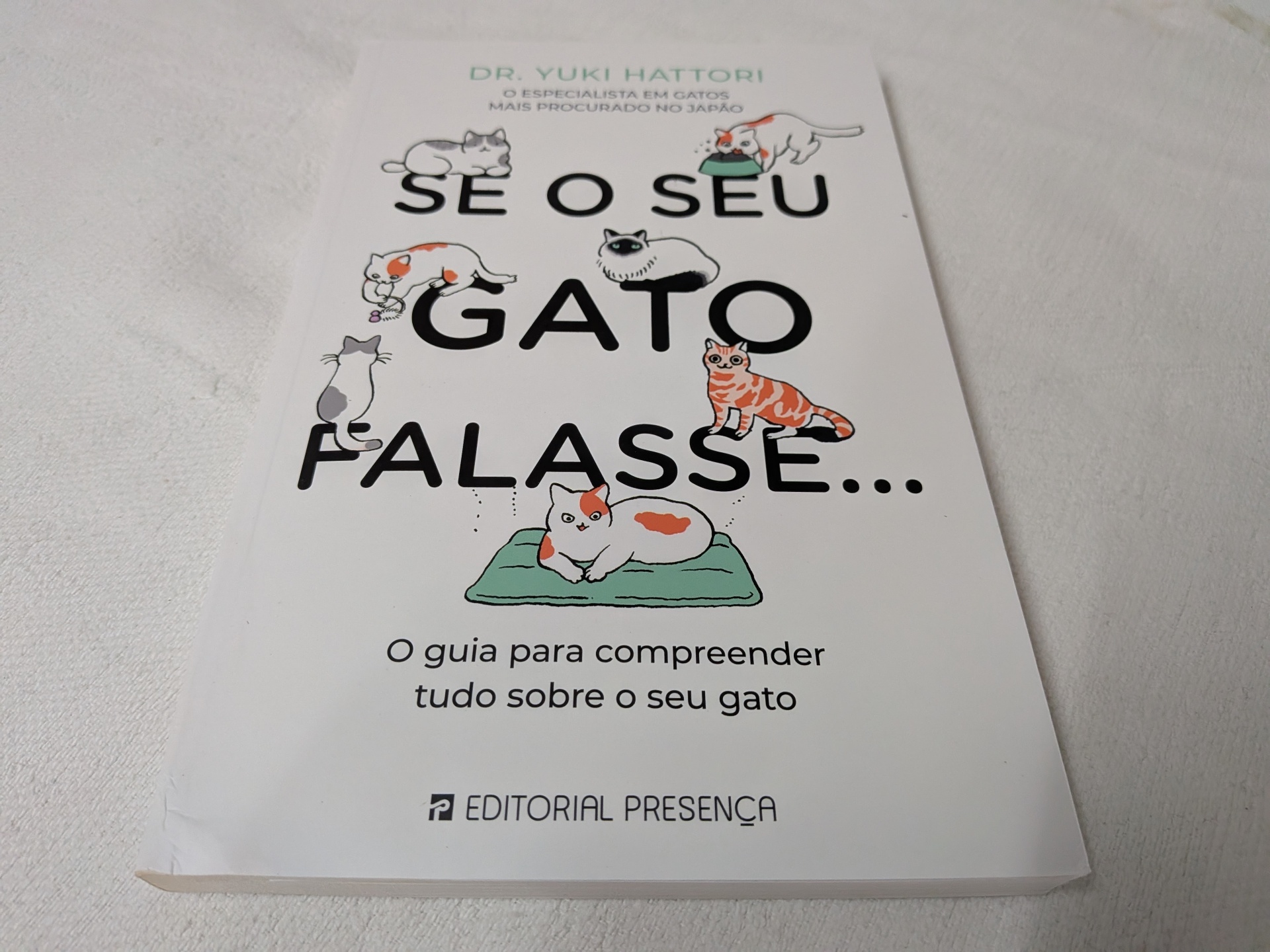 Dr. Yuki Hattori - Se o Seu Gato Falasse… Capa de livro com título 'Se o seu gato falasse...' e ilustrações de gatos coloridos