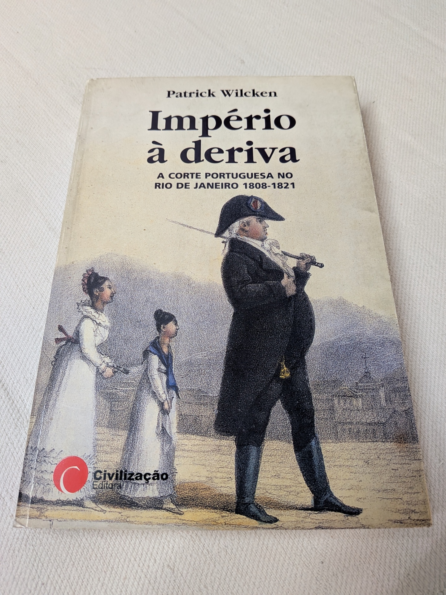 Patrick Wilcken - Império à Deriva (A Corte Portuguesa no Rio de Janeiro 1808-1821) Capa do livro Império à deriva com ilustração histórica e logo da editora Civilização
