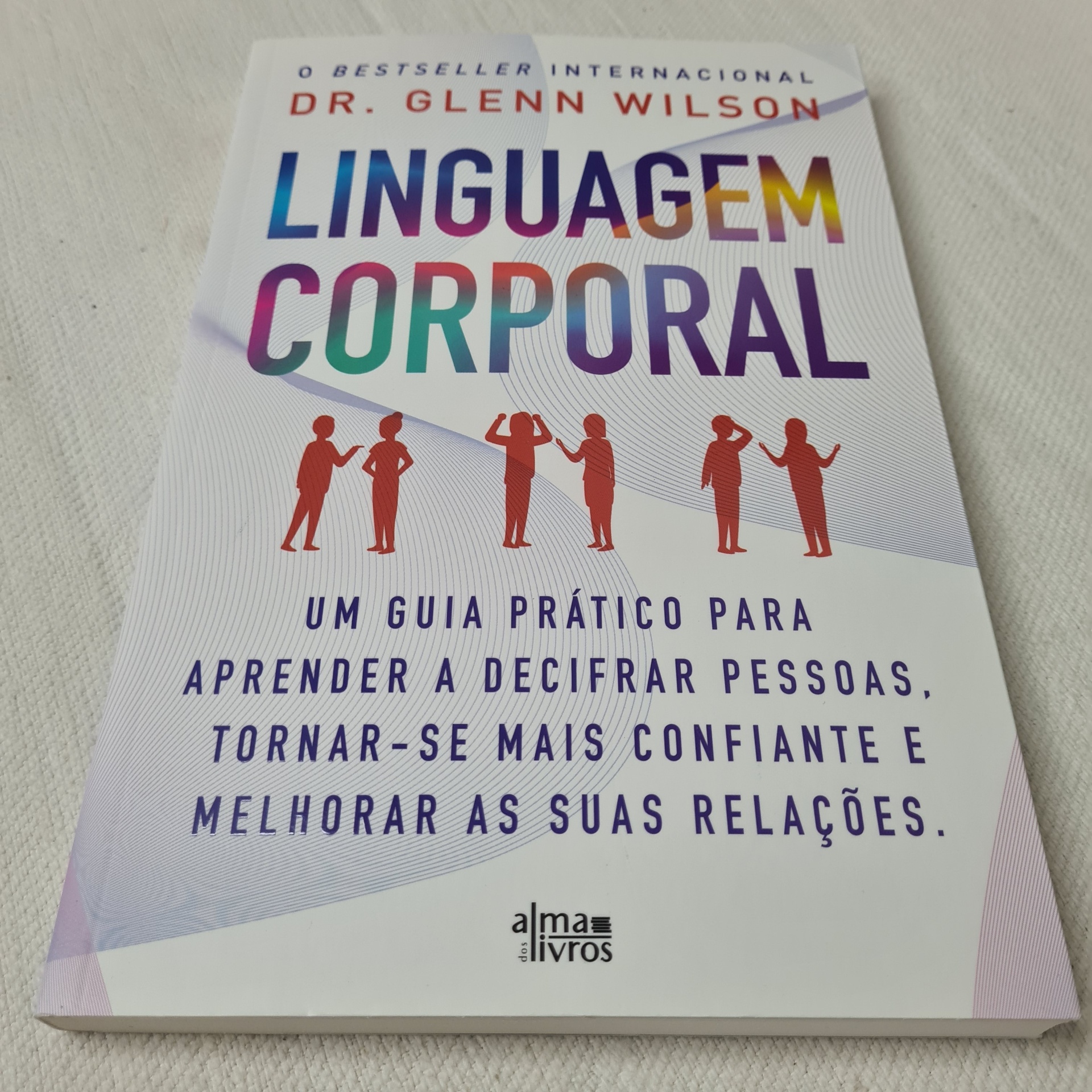 Dr. Glenn Wilson - Linguagem Corporal Capa de livro 'Linguagem Corporal' com texto colorido e figuras vermelhas de pessoas